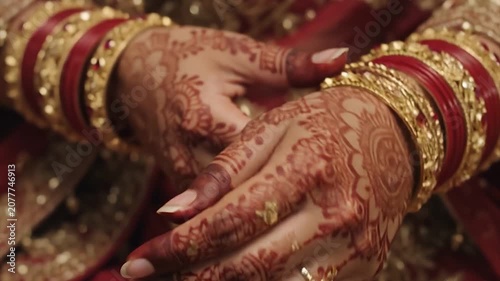 Detailed Close-Up of an Indian Bride Adjusting Her Golden Wedding Bangles