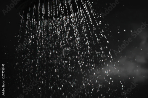 Close-Up of Running Shower Head with Flowing Water on a Black Background