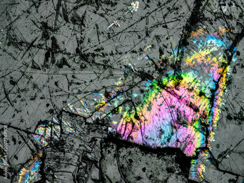 Canvas Print Interference colors in Iceland spar crystal viewed under reflected light microsc