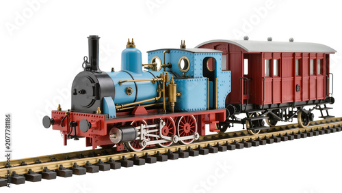 Blue steam locomotive with red passenger carriage on railway tracks