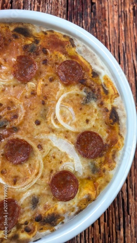 Traditional Italian pizza topped with salami and onions
