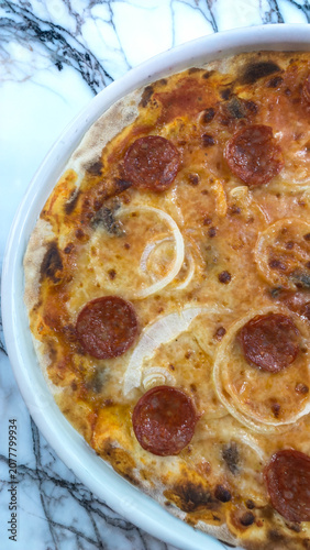 Traditional Italian pizza topped with salami and onions