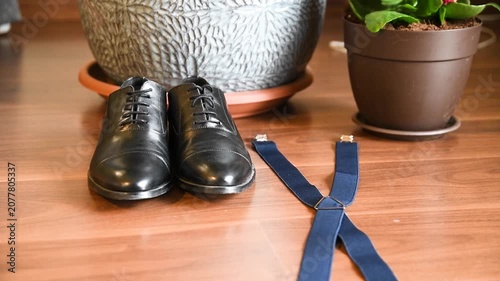 Black leather dress shoes and elegant suspenders for men fashion background