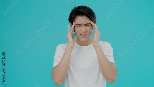 Headache, male having migraine pain, bad health, Asian man feeling stress and headache, Office syndrome, sad tired touching forehead having migraine or depression, irritated girl, sadness grief