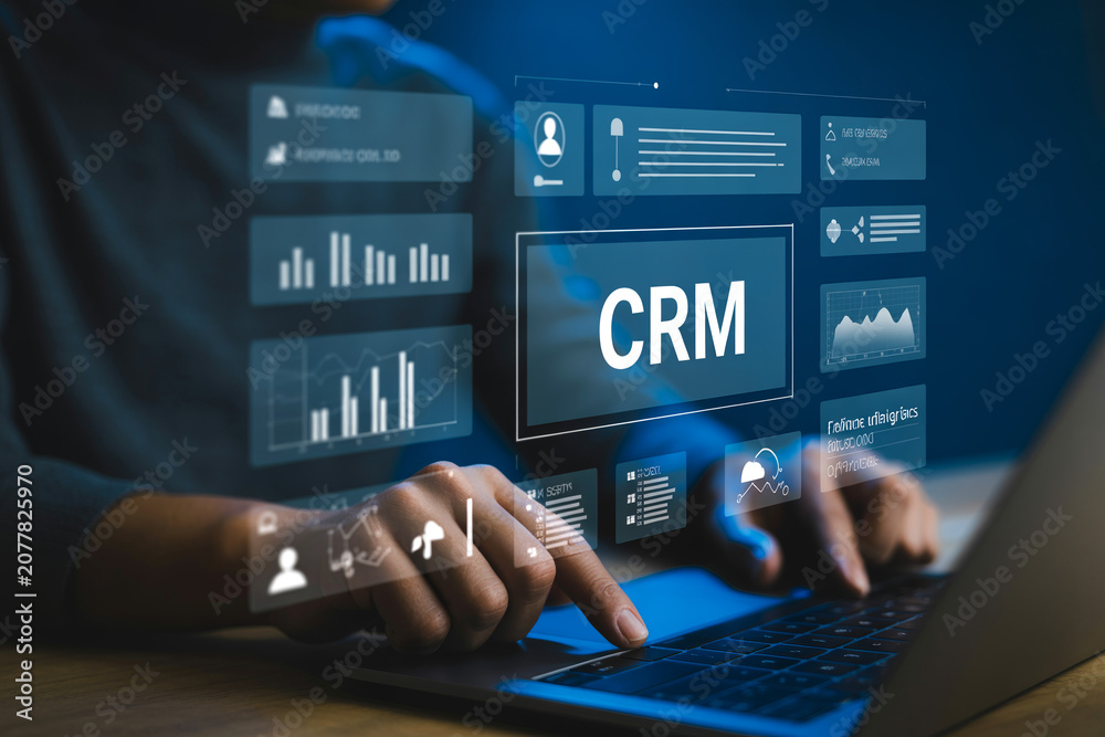 Fototapeta premium Business professional using customer relationship management software interface on laptop with data analytics and charts.
