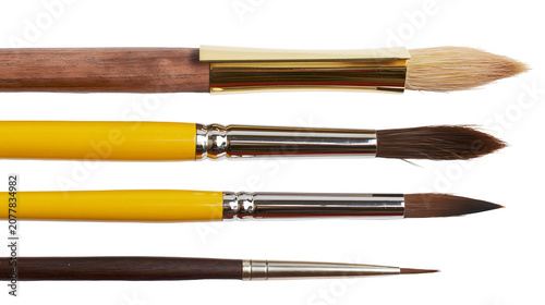 Tableau sur toile Set of four artist paint brushes with wooden and yellow handles