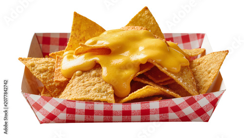 Corn tortilla chips with melted cheese sauce in red checkered paper tray