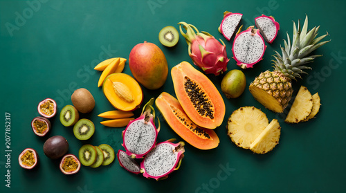Organic Grocery Flat Lays Exotic Tropical Fruit Arrangement on Deep Green Background