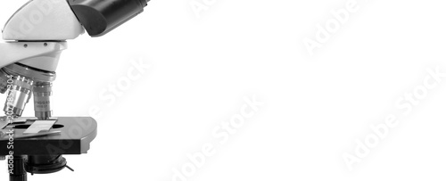 Laboratory microscope banner with glass slide on white background, wide scientific research concept with large copy space.