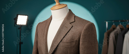 Stylish brown herringbone tweed blazer on a mannequin for product photography in a modern studio