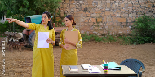 Canvastavla Indian young adult gen z lady female hold files look talk share study learn plan new idea standing rural area