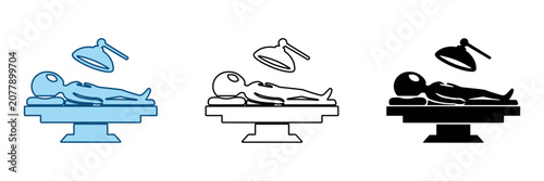 Photos Alien examination table with surgical lamp and extraterrestrial being lying down