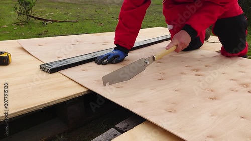 Japanese Saw or pull saw Cutting Plywood Board with Precision During Woodworking Project