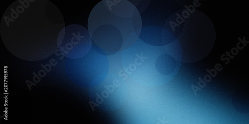 Картината върху платно Atmospheric dark background featuring soft glowing blue circles in hazy bokeh effect over grainy black textured surface layer