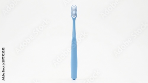 A simple blue toothbrush with white bristles isolated on white background