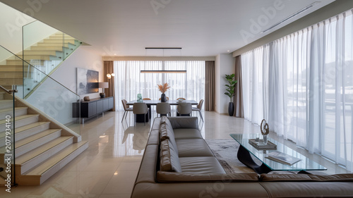Modern open plan living room with dining area and large windows