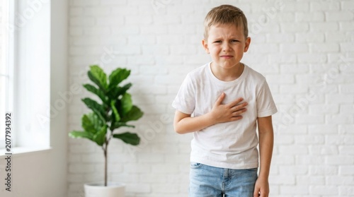 Sick child with chest pain young boy experiencing heart discomfort and illness