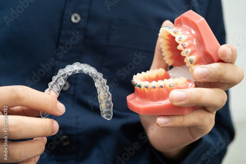 Konstfotografi Man holding invisible aligner orthodontic retainer for dental teeth straightening