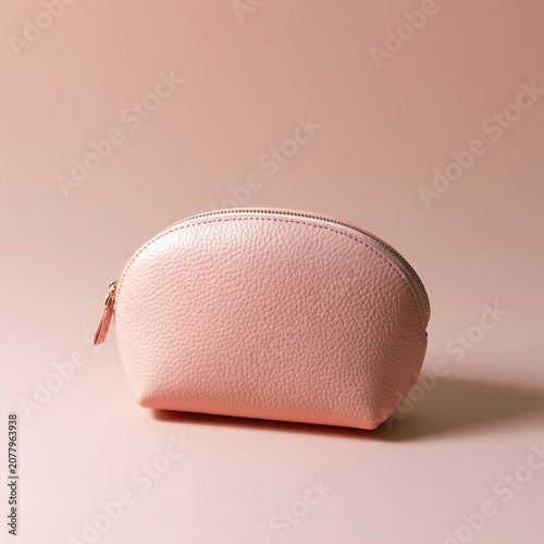 Stylish pink cosmetic pouch on a soft surface.