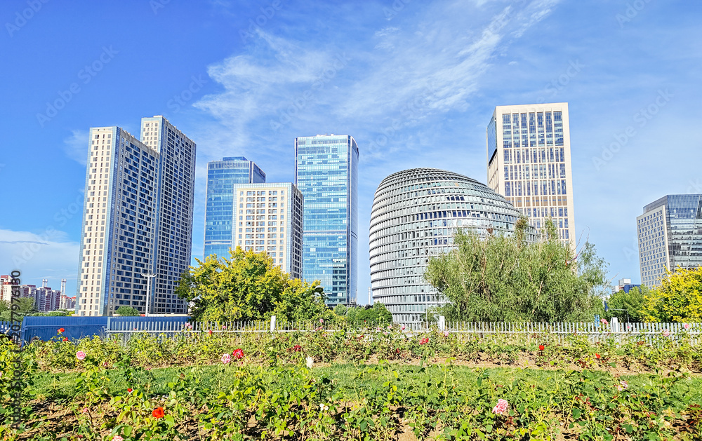 Fototapeta premium Architectural abstract close-up view of the modern curved facade of Chengao Mansion and a glass skyscraper in the Olympic Business District, Chaoyang, Beijing, China
