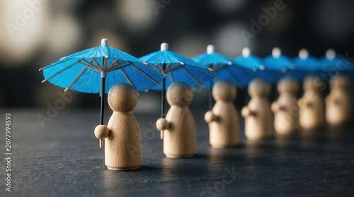 A row of blue umbrellas shielding wooden figures to symbolize group insurance.