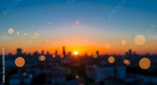 Sunset over city skyline with bokeh lights effect at dusk