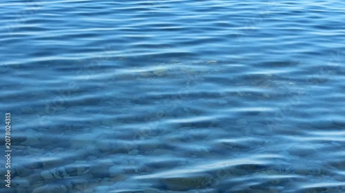 Sea soft sound of waves washing over the pebbles in morning.