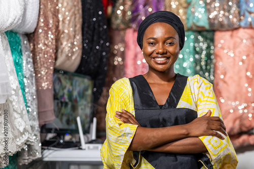 Bild auf Leinwand Smiling african woman entrepreneur, small business owner standing with arms cros