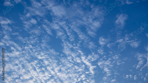 Konstfotografi Blue sky with scattered white cirrocumulus clouds on a sunny day