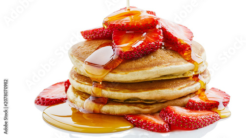Photos Stack of golden pancakes with fresh strawberries and dripping syrup, isolated on