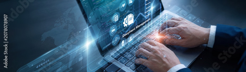 Schilderij op canvas Records manager is diligently managing digital files using laptop for the Document Management network protocols to ensure absolute data safety