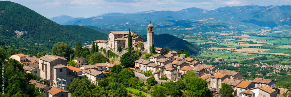 Fototapeta premium Greccio Rieti Italy High Resolution. 16k 3:1 drone panorama of narrow hilltop medieval borgo on 70mm lens with background valley and mountains. Borghi piu belli d Italia most beautiful villages