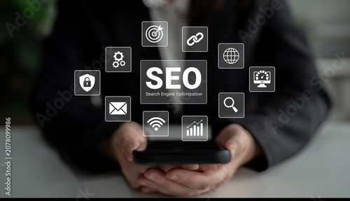Картината върху платно A smartphone held by hands displays various SEO-themed icons, representing crucial digital marketing concepts in a modern business setup focused on online visibility and growth