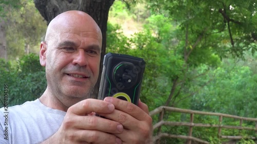 Closeup of a man using a phone outdoors