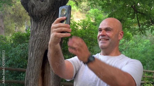Man in the park video calling.