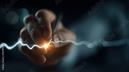 Hand holding pen creates glowing, futuristic signature with holographic effect, symbolizing digital approval and innovation. scene is dark, highlighting bright signature line
