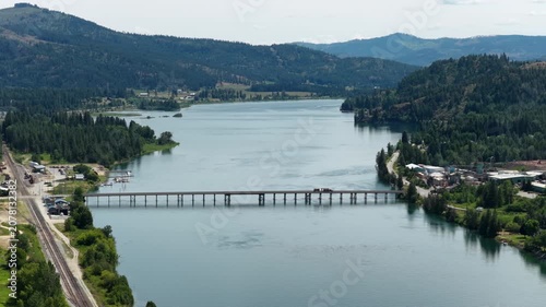 Aerial of bridge crossing Priest River and railroad tracks in Idaho in summer in Bonner County
