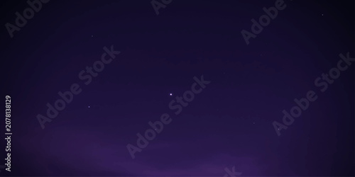A clear night sky filled with countless stars and a crescent moon, captured during a long exposure, showcasing the vastness of the cosmos.