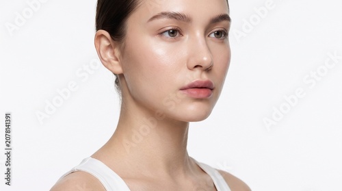 Young woman portrait neck to belly, glass skin glow, ombre lips, defined brows, tri-light studio, skincare editorial photo.