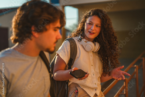 Students conversing on campus enjoying sunset light
