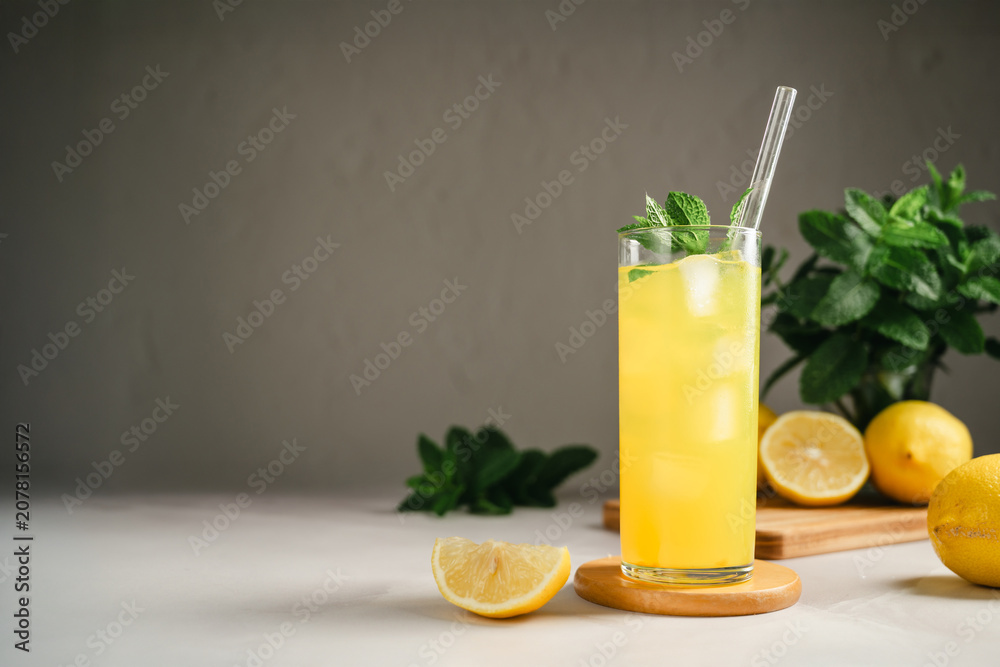 Fototapeta premium Chilled lemonade with mint and ice in tall glass, refreshing summer beverage concept, copy space