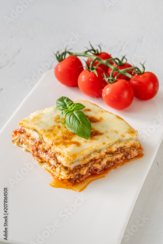 Overhead Lasagna With Golden Mozzarella Basil And Fresh Cherry Tomatoes