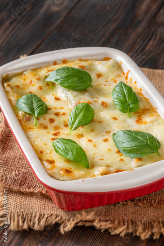 Rustic Lasagna Bolognese In Ceramic Baking Dish With Golden Cheese Topping