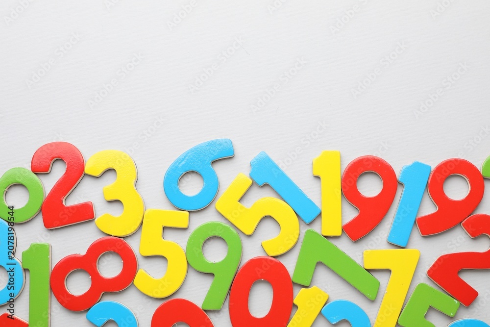 Fototapeta premium Many colorful numbers on grey background, flat lay. Space for text