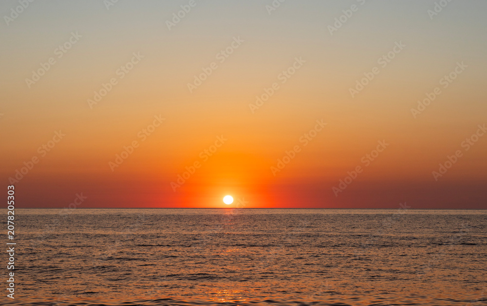 Fototapeta premium Beautiful sunset over the sea with wave. Evening sea landscape