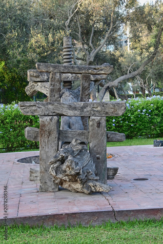 Antique olive oil press in el olivar park, lima