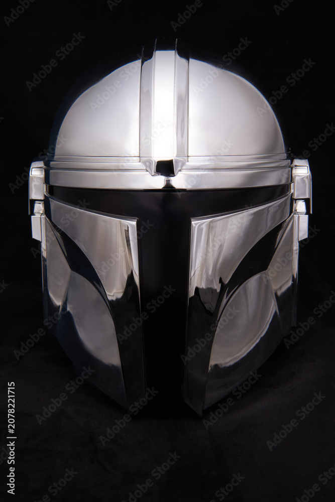 Obraz premium Professional photograph of a Mandalorean helmet on dark velvet, captured in El Salvador, Cinepolis on June 26, 2026.