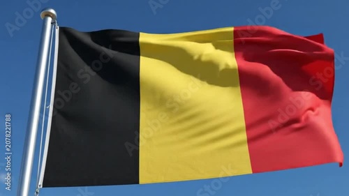 Flag of belgium waving in the wind against a clear blue sky