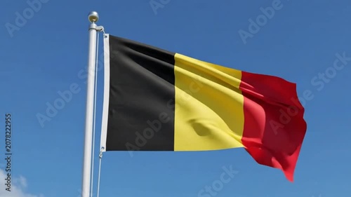 Flag of belgium waving in the wind against a clear blue sky