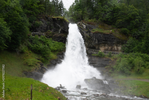 Steinsdalsfossen is a huge waterfall in Norway, making it possible to walk behind the curtain of water